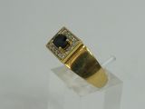 a close up of a gold ring with a black stone on it