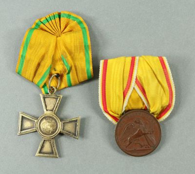 two medals and a medal on a gray surface