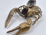 an image of a gold crab with a pair of eyes on it ' s back