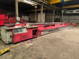 a red machine that is sitting in a warehouse
