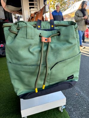 a green bag that is sitting on top of a cart