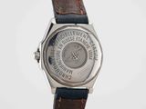 a close up of a wrist watch with a brown leather strap