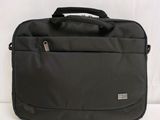 the laptop bag is sitting on a white surface with a black handle