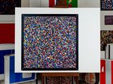 brightly colored sprinkles are displayed in a white frame in a room
