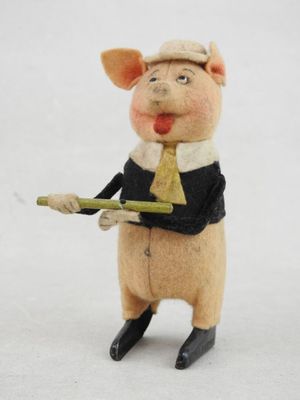 a figurine of a pig wearing a tie and holding a stick