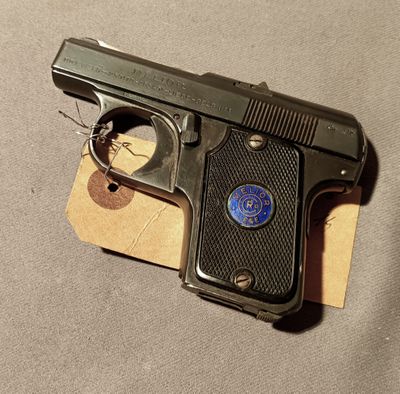 a gun that is laying on a piece of paper