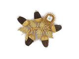 a gold brooch with flowers and leaves on a white background