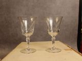 two wine glasses sitting on top of a wooden box