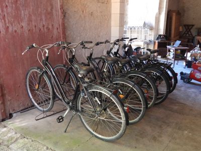a lot of bikes that are lined up in a garage