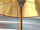 a yellow umbrella with a chain hanging from the top of it