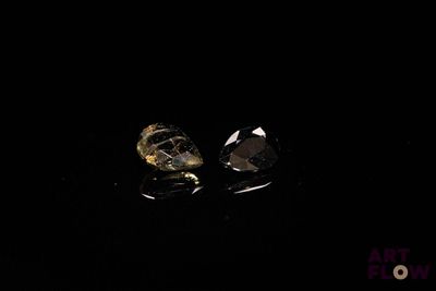 pair of skull earrings in the dark with a black background