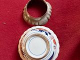 a small bowl and a ring on a red table