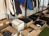 many boxes of clothes on a rack in a room