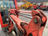an image of a large red machine in a parking lot