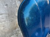 a close up of a blue seat on a motorcycle