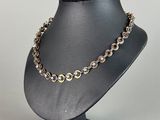 a close up of a necklace on a mannequin stand