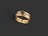 a gold ring with a sapphire stone and diamonds
