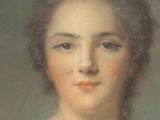 portrait of a woman in a white dress with a flower in her hair