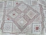an image of a white and red patchwork rug on a table
