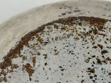 a close up view of a metal object with dirt on it