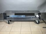 an image of a metal table with wheels on it
