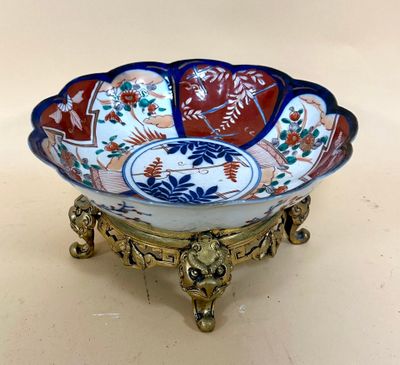 a close up of a decorative bowl on a stand on a table