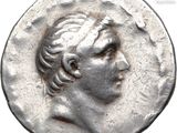 a close up of a silver coin with a man ' s face on it
