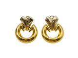 an image of a pair of gold earrings on a white background
