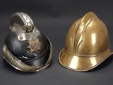pair of firemen ' s helmets on a black background