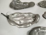 five pieces of metal that are sitting on a table