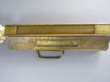 an old brass box with a ruler and rope hanging from it