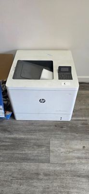 a white printer sitting on the floor next to a box