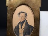 an old picture of a man in a suit and tie sitting next to a business card holder