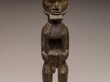 a wooden statue of a man with a helmet on his head