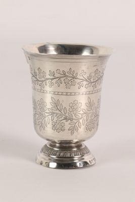 a silver cup that is sitting on top of a table