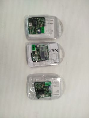 three cell phones that are in plastic bags on a table