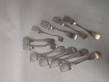 several forks and spoons arranged in a circle on a table