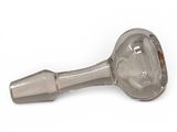a glass pipe with a metal handle on a white surface