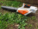 a leaf blower sitting on the ground in the grass