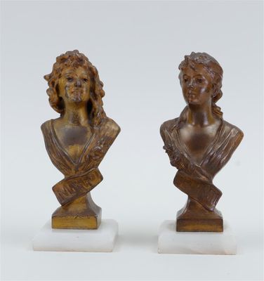 pair of bronze busts of a woman and a man on marble bases