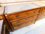 a wooden dresser with a marble top in a room