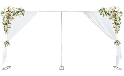 a white wedding arch decorated with white flowers and greenery