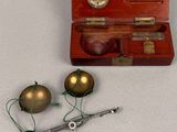 a small wooden box with two ornaments and a pair of scissors