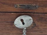 an old key that is attached to a wooden box
