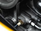 a close up of a car ' s engine with a hose connected to it