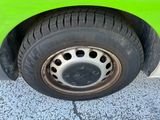 a close up of a tire on a green car