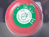 a red frisbee with a green and white label on it
