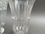two glass vases sitting next to each other on a table