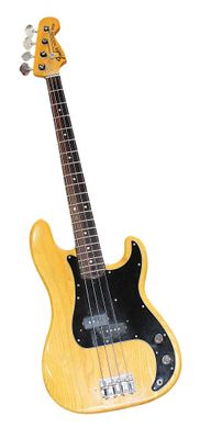 a yellow electric bass guitar on a white background