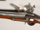 a close up of a gun with a knife on it